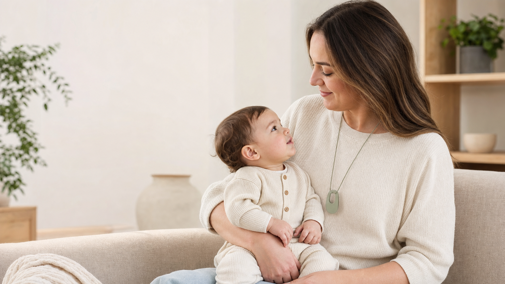 Caregiver wearing a silicone nursing necklace during a supervised moment